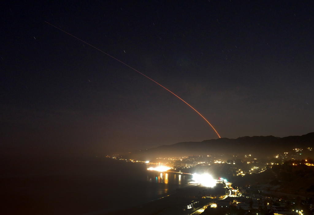 Trail of glowing booster exhaust gases while Atlas-V is launched from the Vandenberg Air Force Base