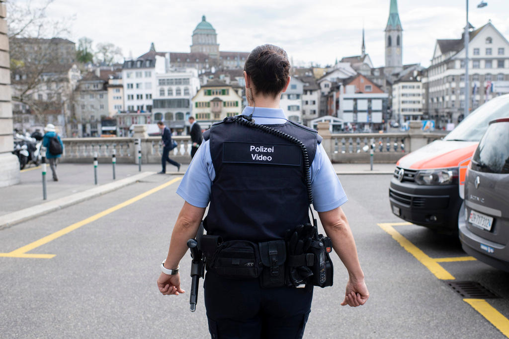 A uniformed Swiss police officer walking in the city of Zurich