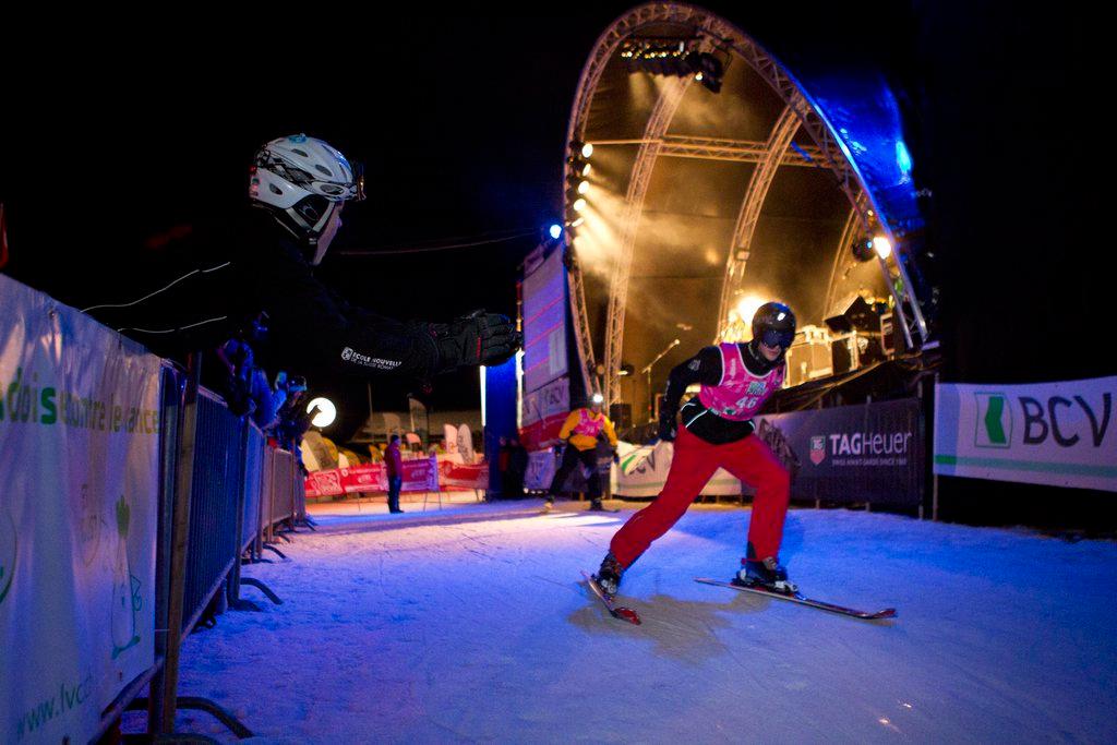 Skier on a flat track lit up at night