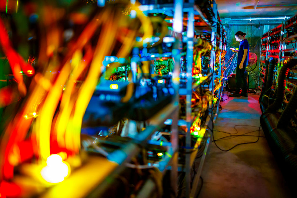 A man stands in a row of computer servers