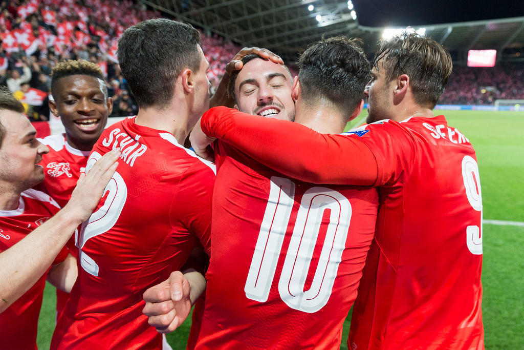 Swiss footballers celebrate a goal