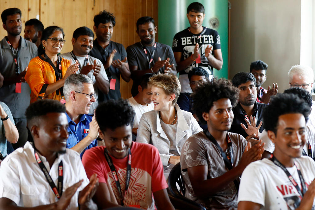 Asylum-seekers clapping during a workshop