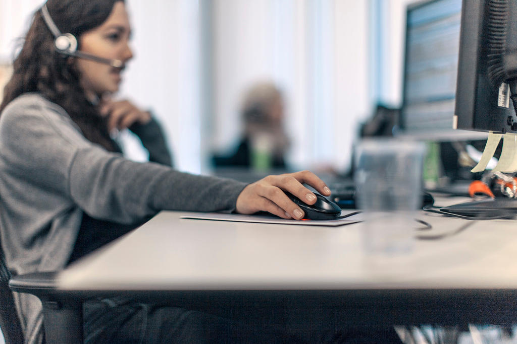 A woman works at a computer