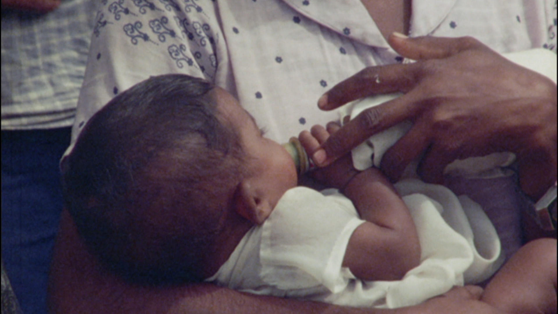 baby in mother s arms with bottle