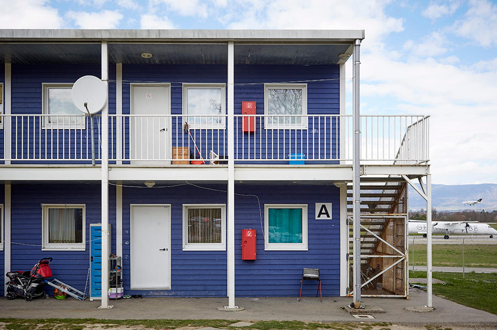 Blue 2 story building with white doors.