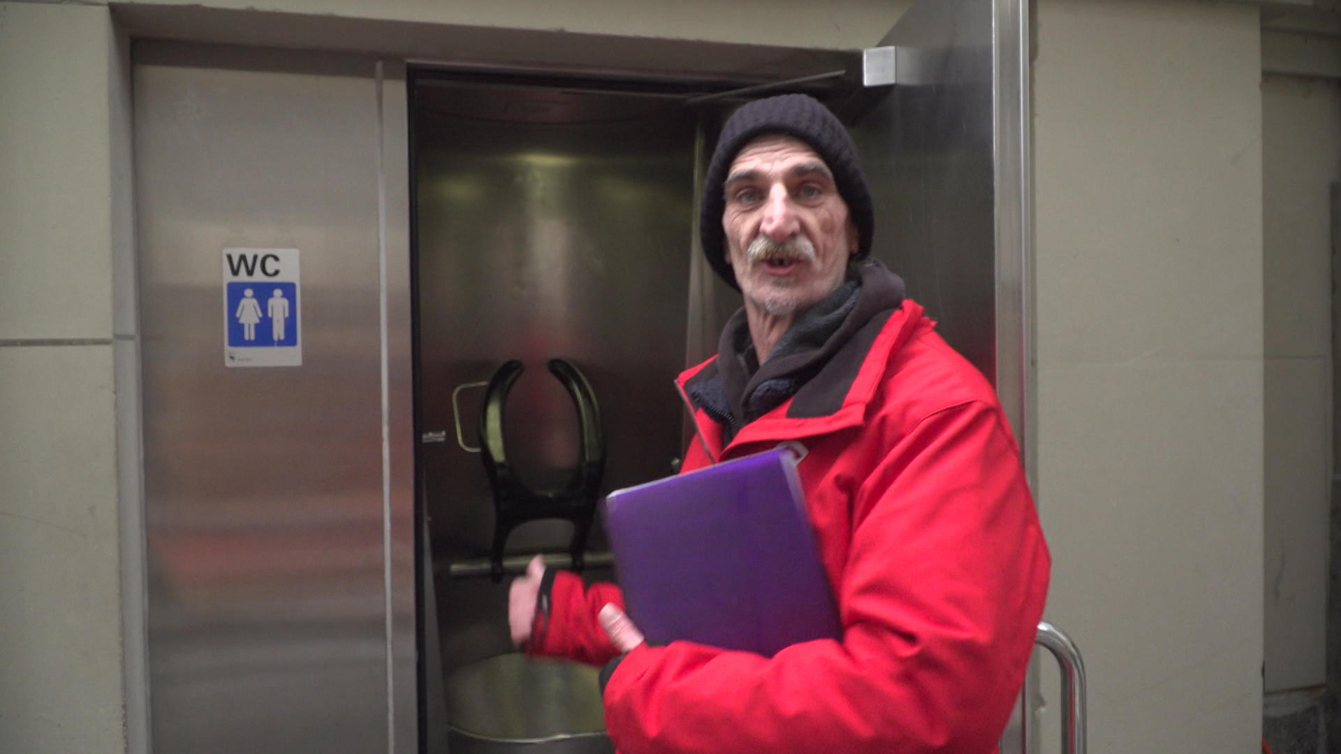 Roger Meier shows a toilet where homeless people sometimes sleep