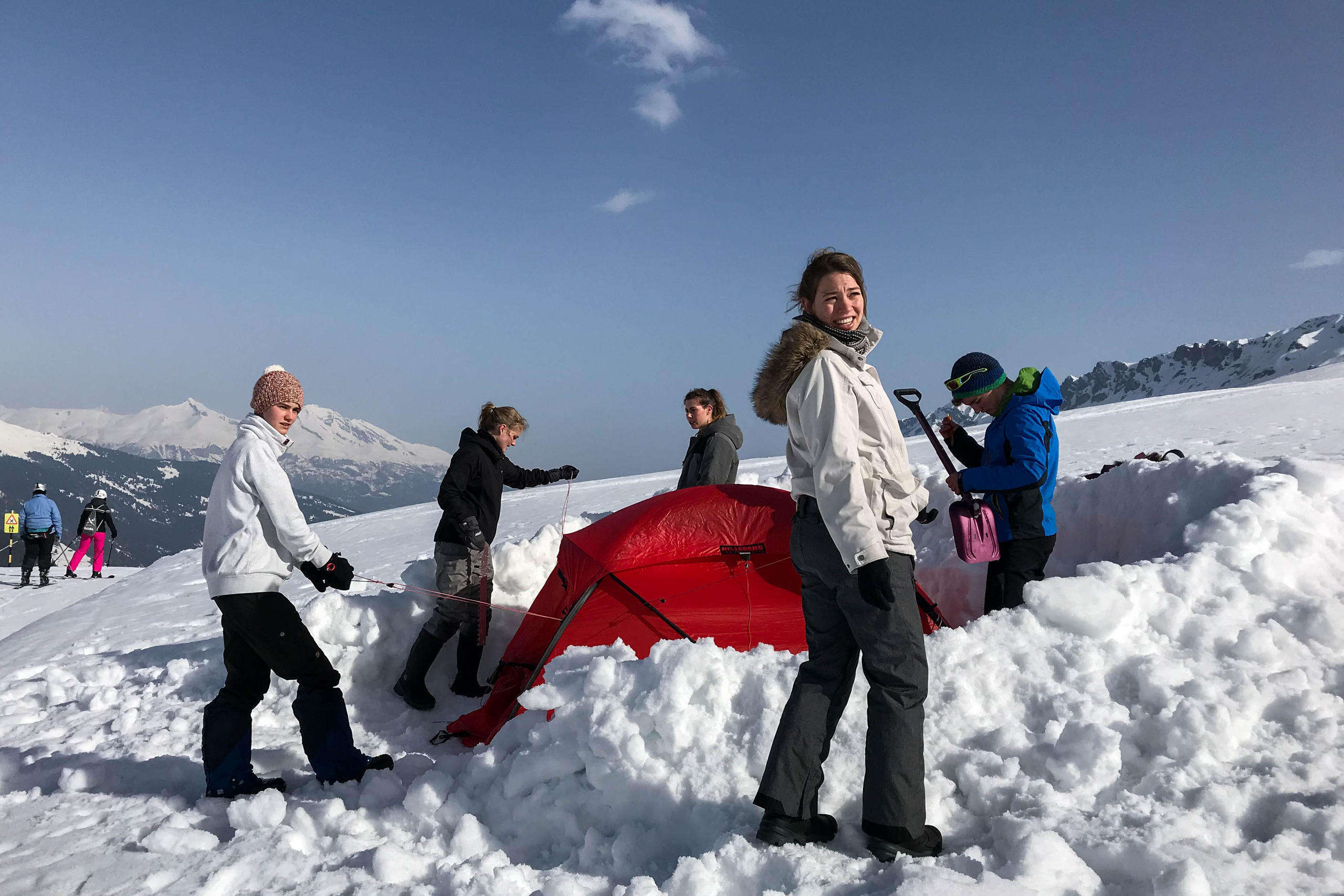 people building a tent in the snow