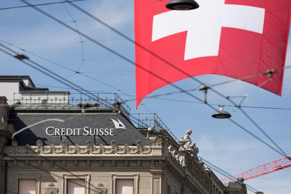 The Credit Suisse headquarters and a Swiss flag on Paradeplatz Square in Zurich