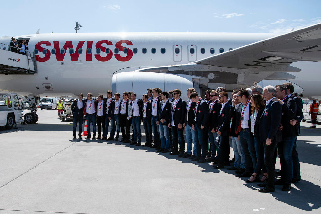 The Swiss ice hockey team in front of a Swiss International plane