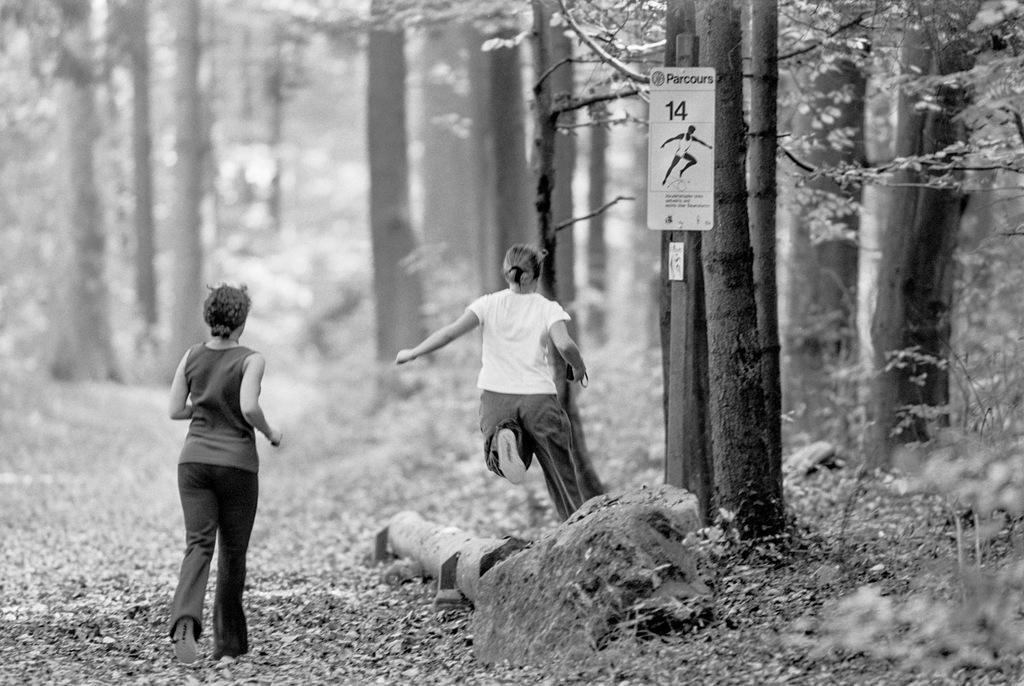 Two schoolchildren running along the trail.