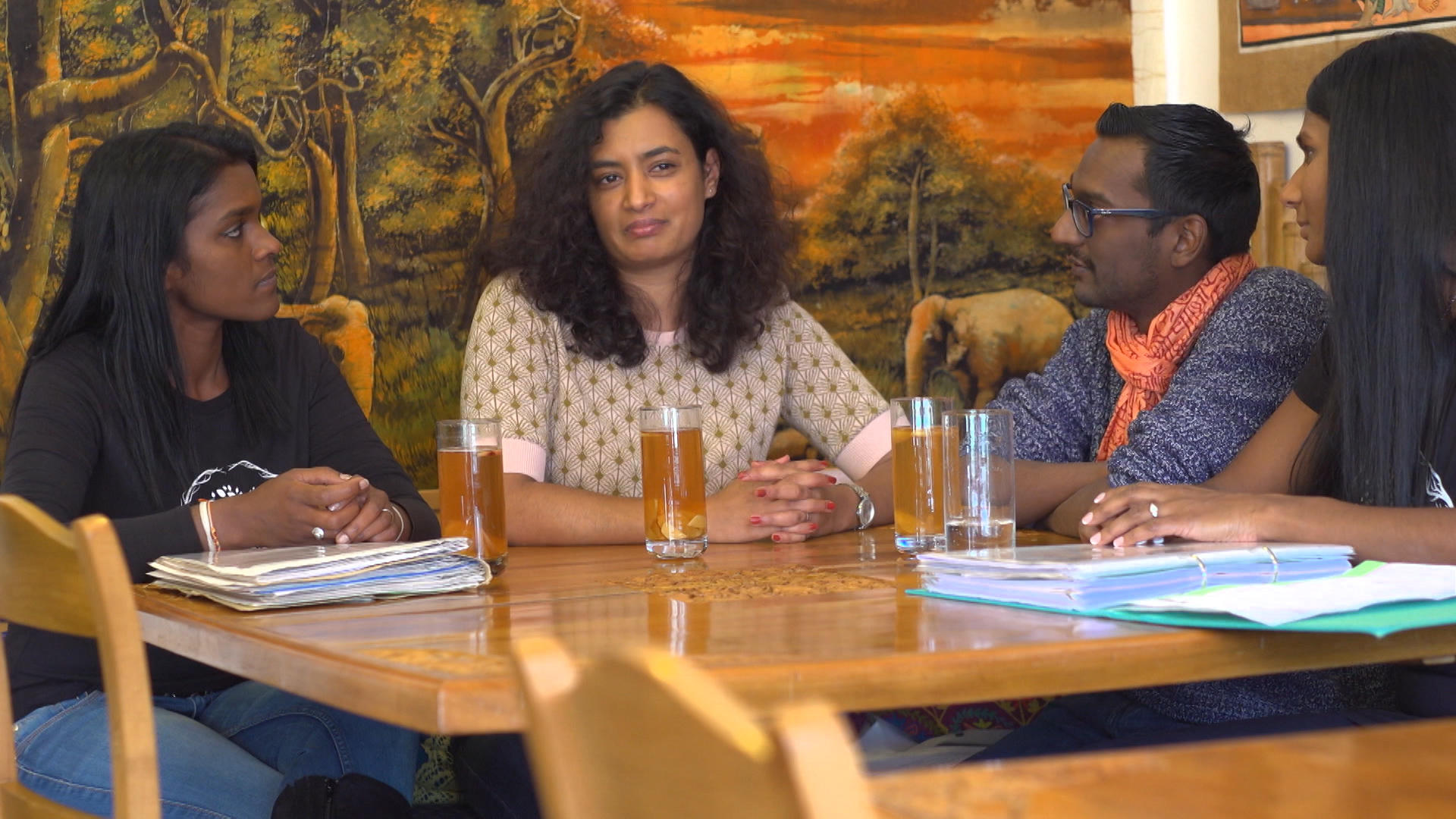 Group of young Sri Lankans sitting around a table