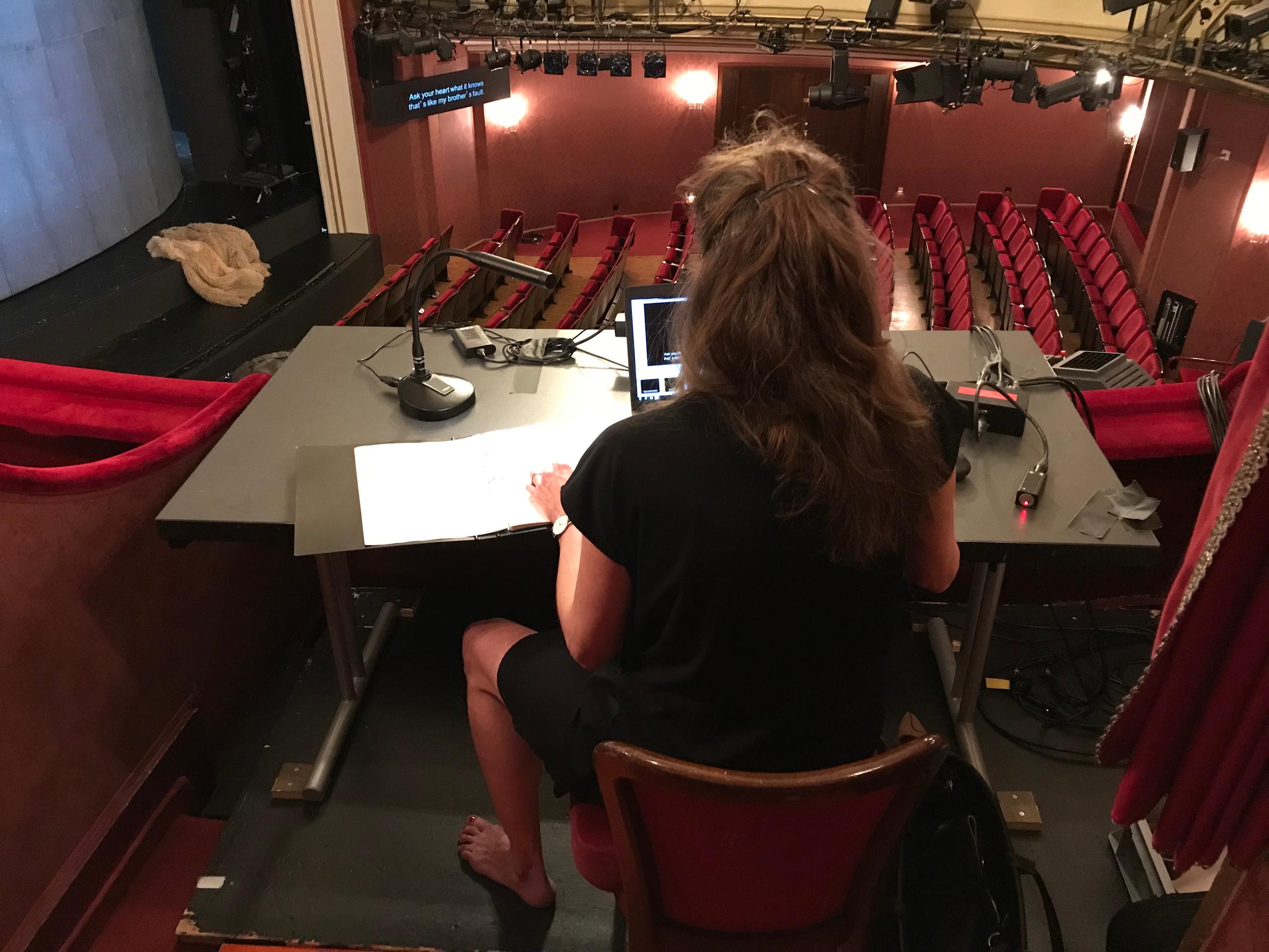 looking over the shoulder of a translator in her booth