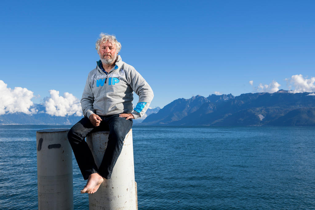 yvan bourgnon sitting above a lake