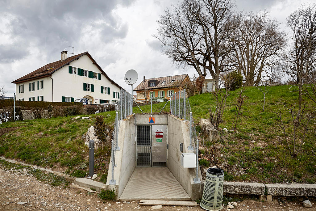 Entrance below a grassy hill