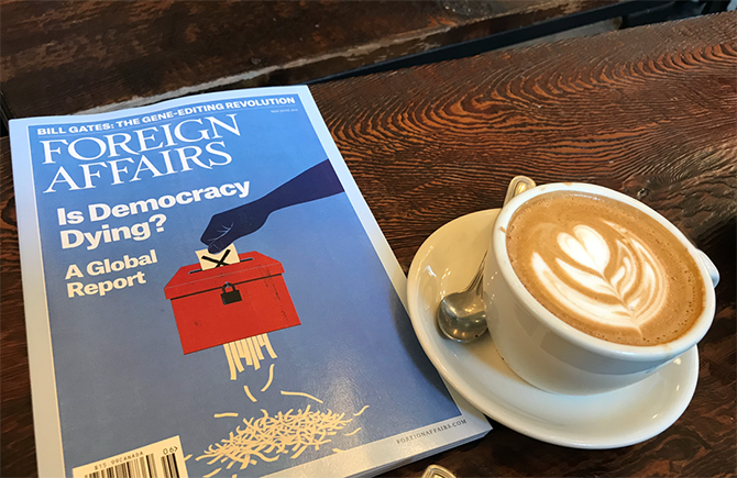 Cup of cappuccino and copy of Foreign Affairs magazine