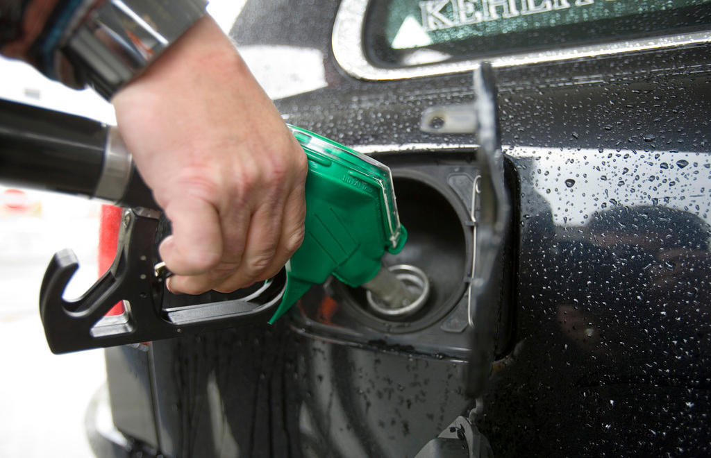 person filling a car with fuel