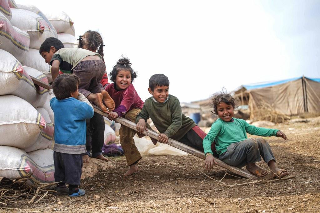 Displaced children play at the Atamah camp, at the Syrian-Turkish border in Idlib province, Syria