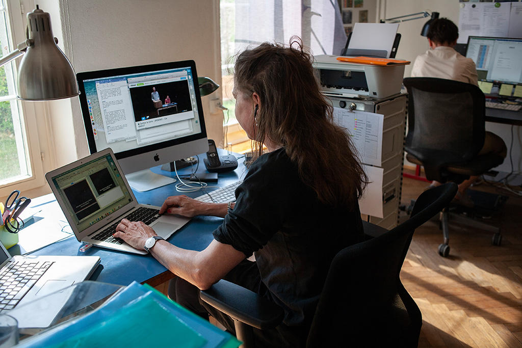 woman sits at computer