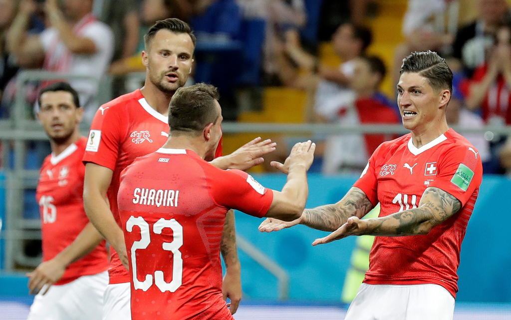 Swiss midfielder Steven Zuber (right) celebrates after scoring the equalizer
