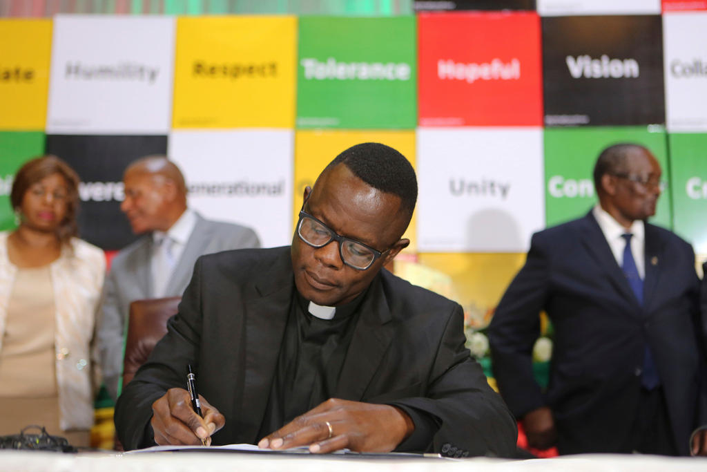 A picture of a pastor also signing the agreement