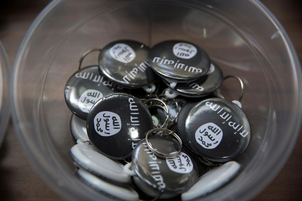 Islamic state group pins are on display at an Islamic bookstore in Istanbul