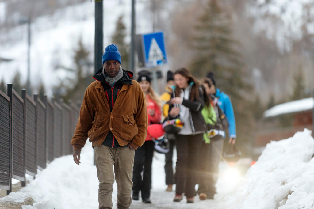 A row of people walking in the snow