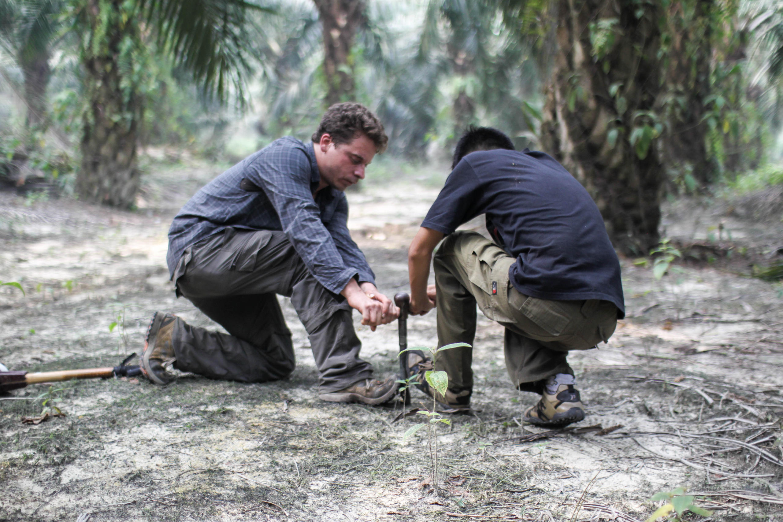 Two men testing the soil.