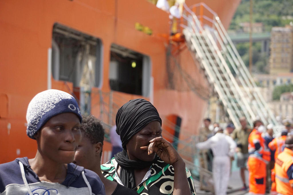 Migrants disembarking from a rescue ship