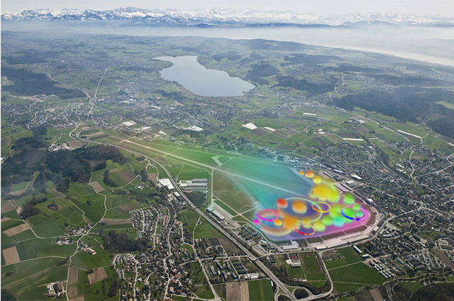 Flugaufnahme vom Flugplatz Dübendorf mit Greifensee im Hintergrund und bunten Punkten an der Stelle, wo die Expo platziert würde