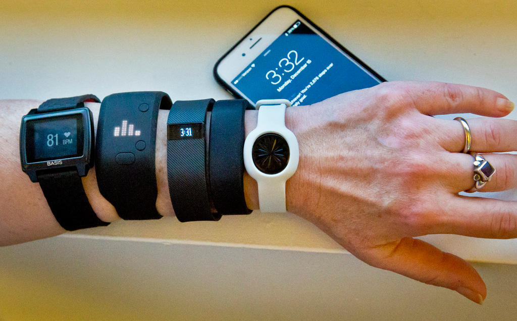 A picture of someone wearing a variety of health tracking devices