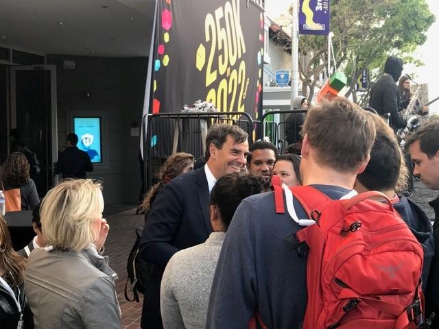 Tim Draper surrounded by people at his private university
