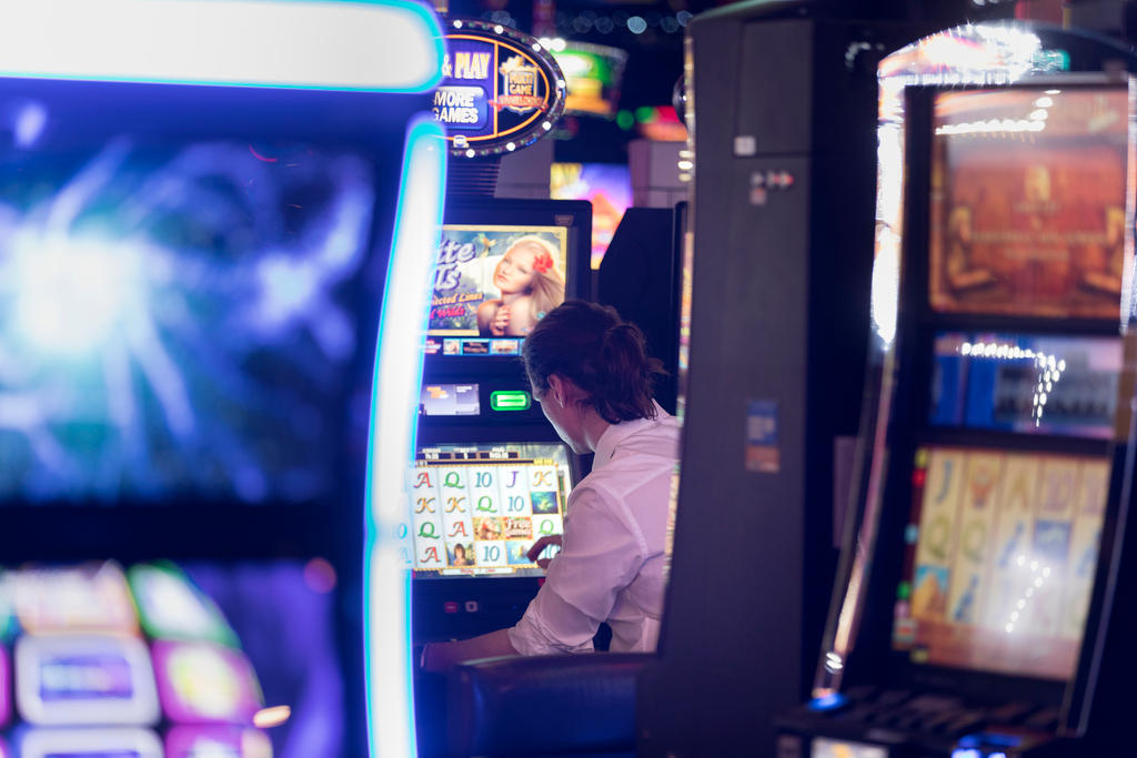 Man sitting in front of a slot machine