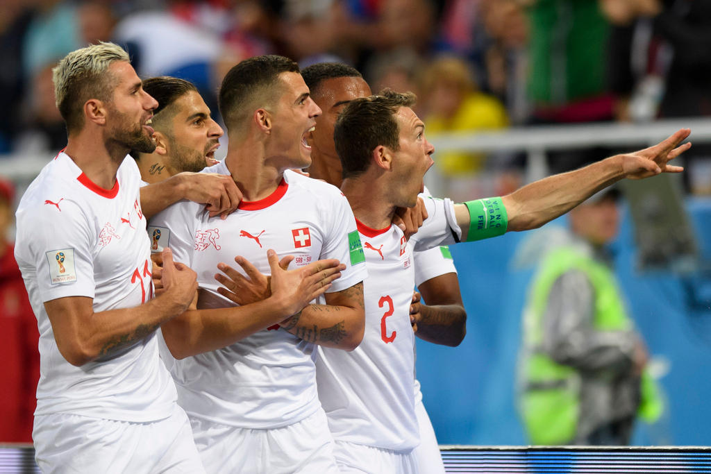 Switzerland s midfielder Granit Xhaka, center, celebrates after scoring a goal with team mates