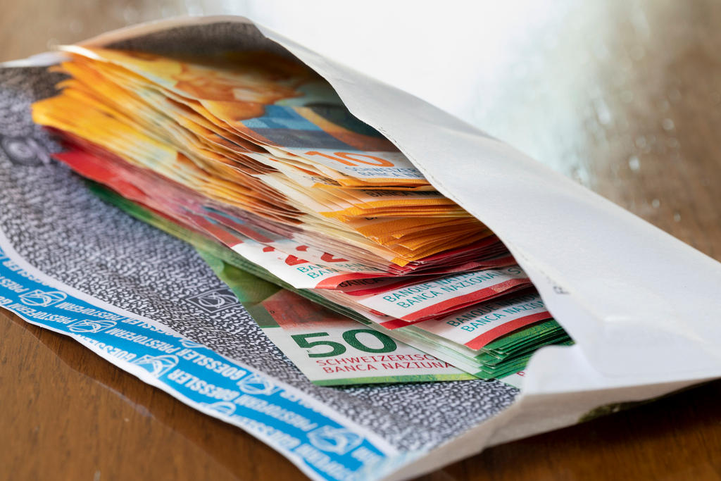 Ten, twenty and fifty Swiss franc bills in an envelope