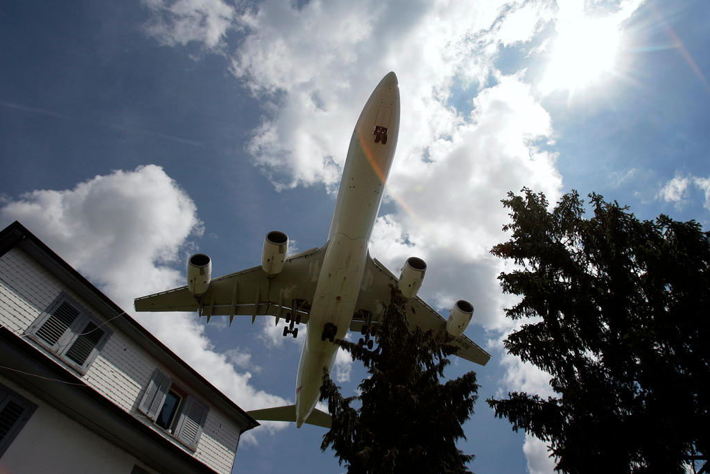 A passenger plane above a house near Zurich airport