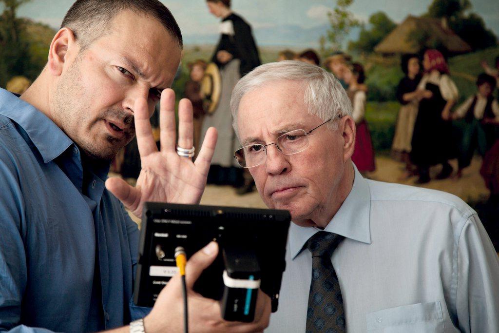 Blocher and filmmaker look into the camera screen