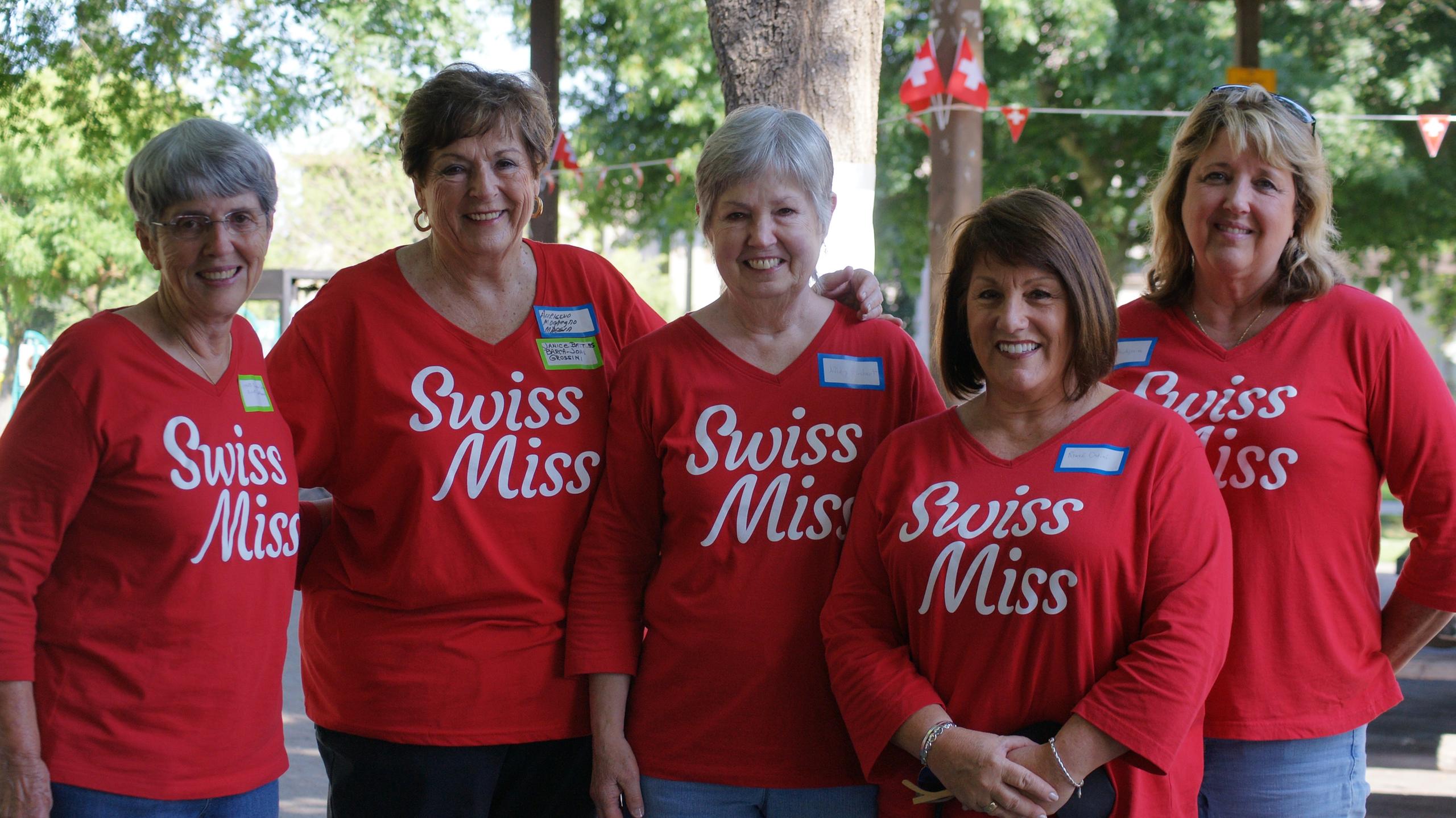 Five women in Swiss Miss red t-shirts posing for the camera