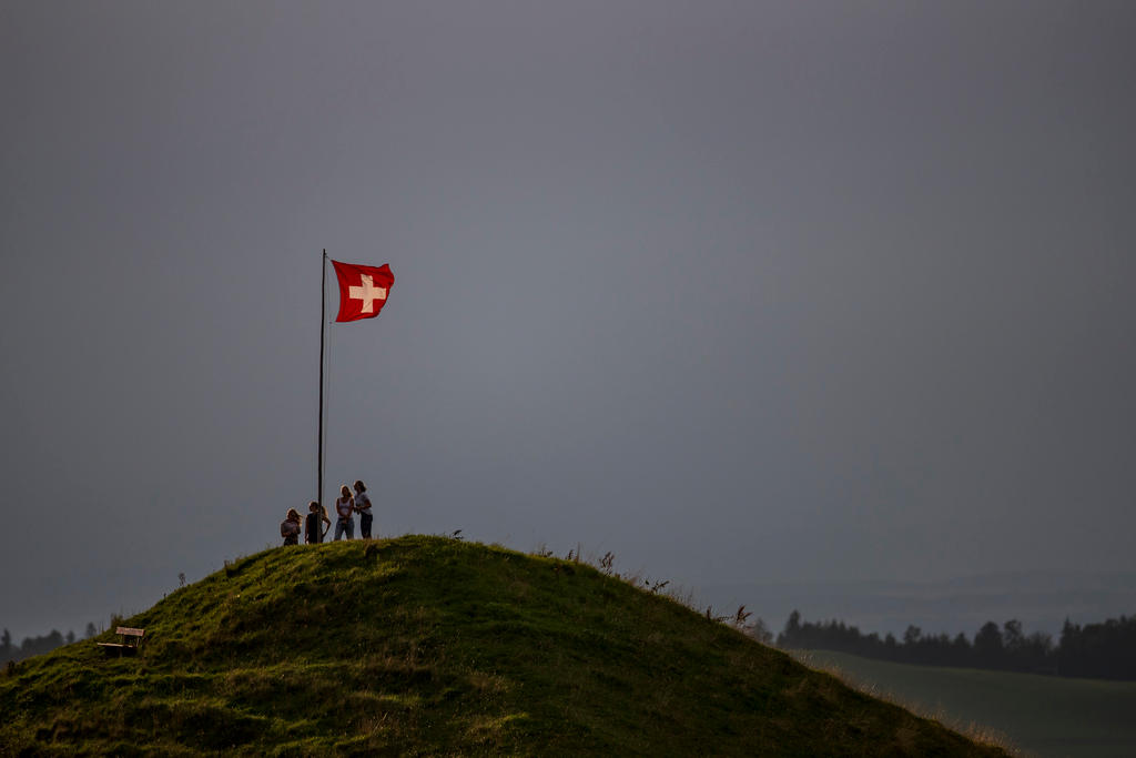 Bandeira suíça no pico de uma montanha.