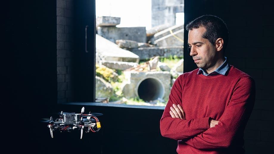 Portrait of Davide Scaramuzza with a flying drone