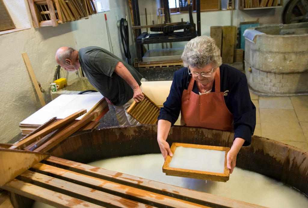 Elderly couple making paper at Basel museum