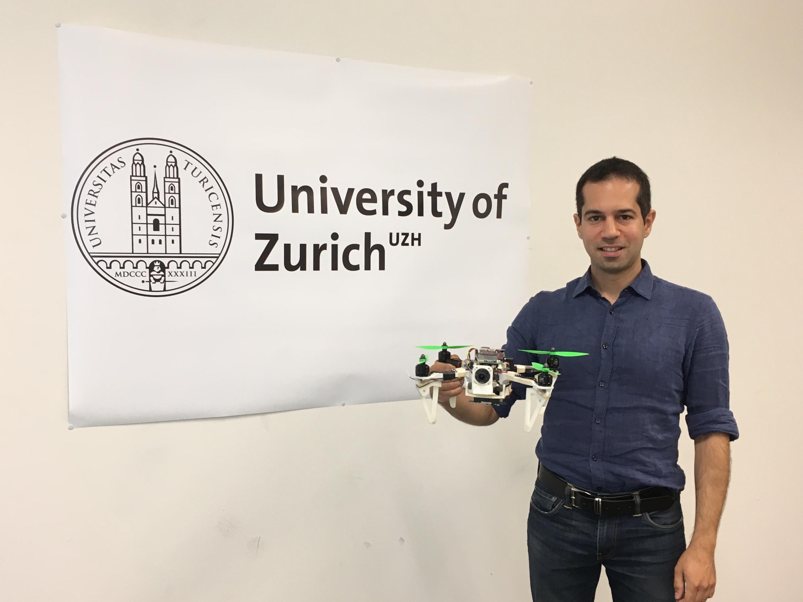 Davide Scaramuzza poses with one of his drone prototypes at the University of Zurich.