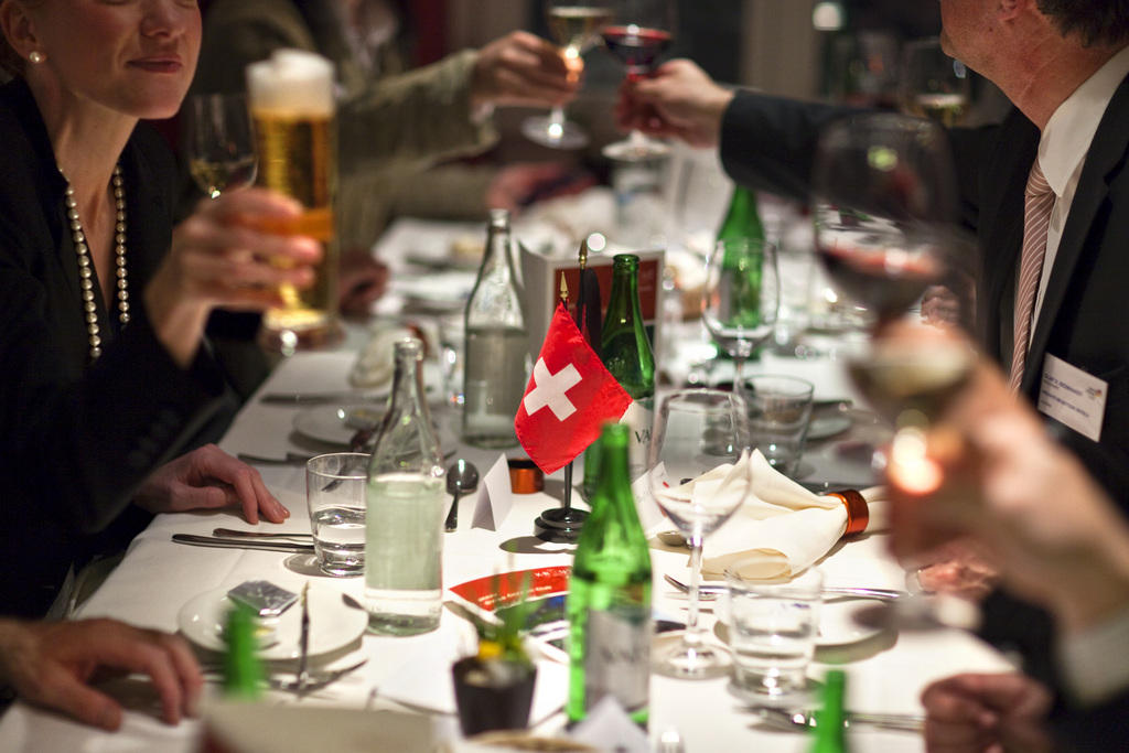 people at a table sharing an alcoholic drink together