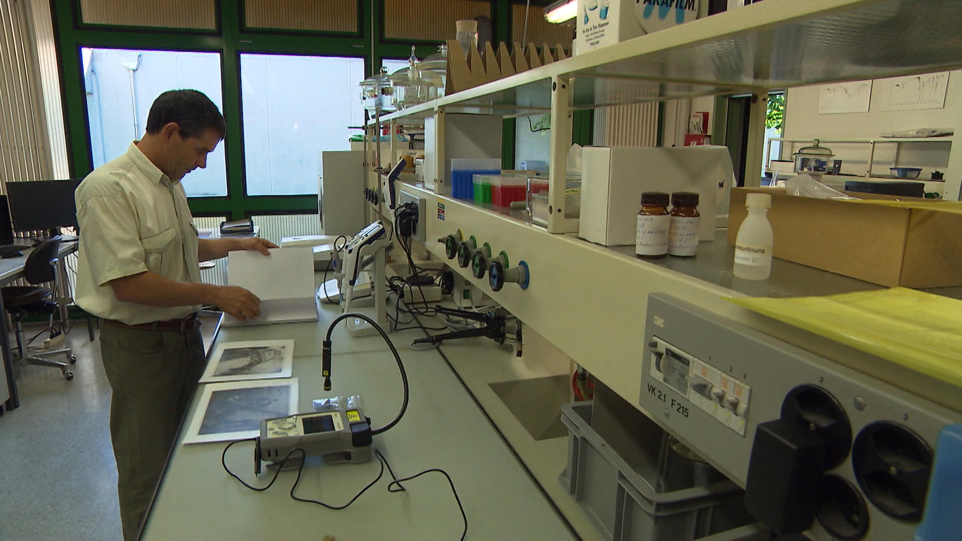 Man looking at ammunition pictures in lab