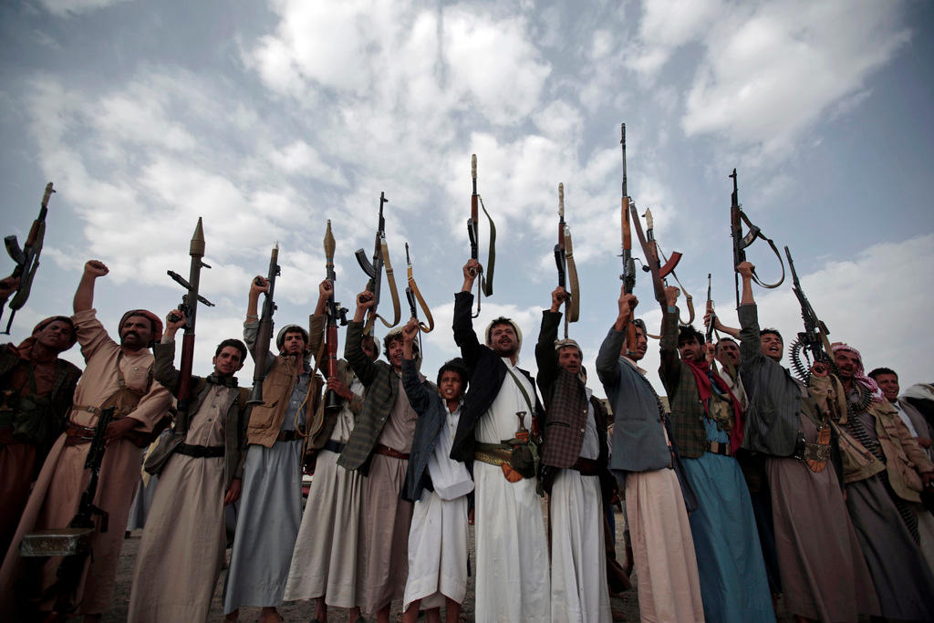 Yemeni gunmen raising their rifles.