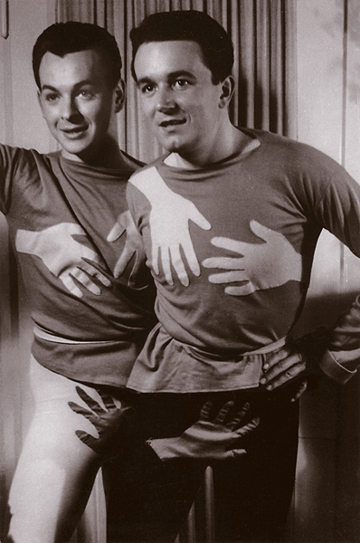 Two men stand next to each other