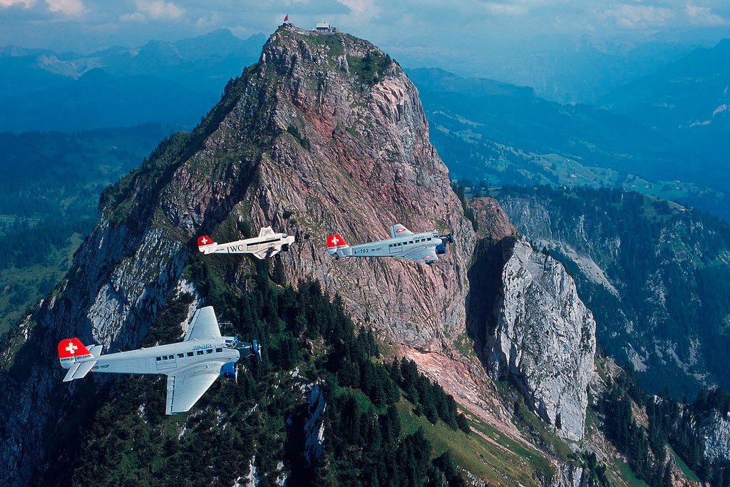 Three Ju-52 aircraft flying in the air.