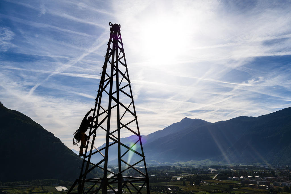 Man climbing a transmission tower