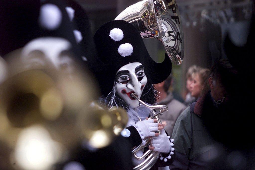 Mascarado tocando tuba