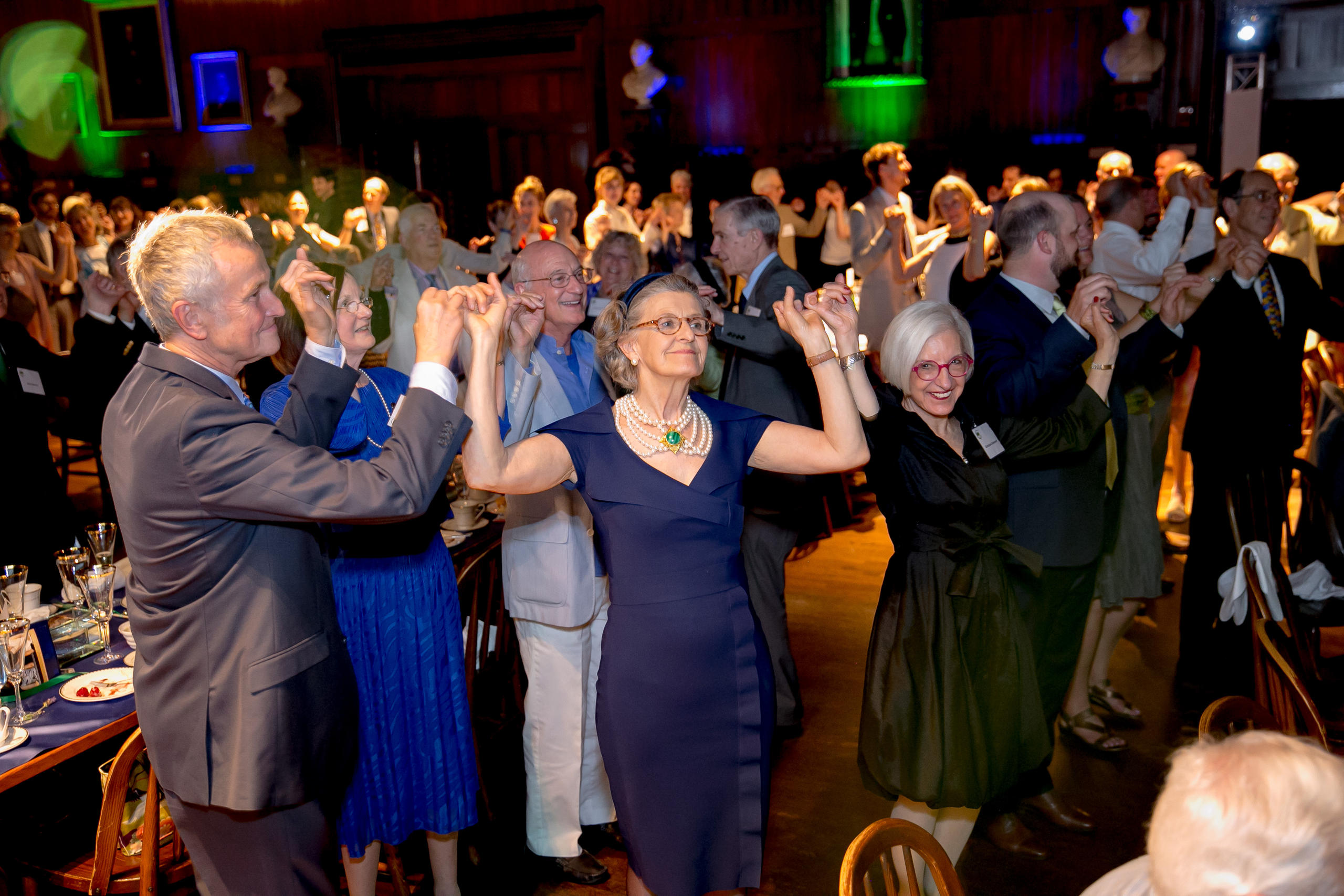 Group of people celebrating, holding hands