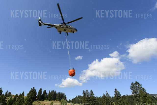 Super Puma helicopter transporting water.